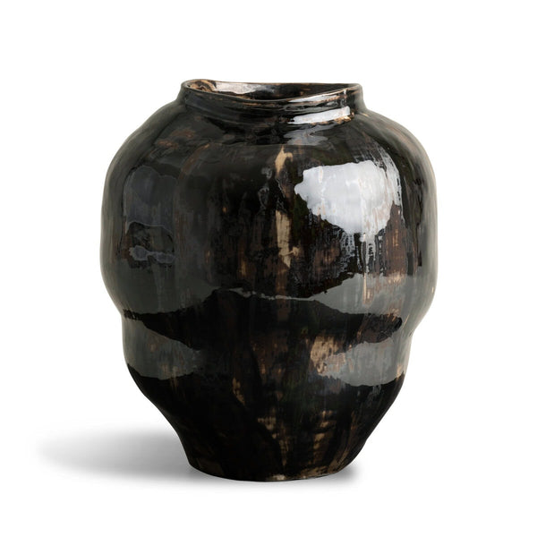 The Fabian Vase by FlowDecor Inc. is a glossy ceramic vessel with a dark hue, irregular rounded shape, and slightly uneven rim, set against a white background.