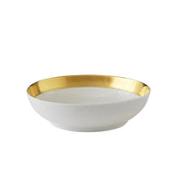 A white ceramic bowl from the Raynaud Mineral Irise Gold Filet Dinnerware collection, featuring a lustrous gold rim on the inside, is set against a plain white background.