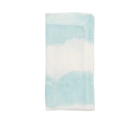 The Kim Seybert Watercolor Stripe Napkin Set of 4 features a light blue and white tie-dye design, perfect for elevating your summer tablescape. Displayed on a white background.