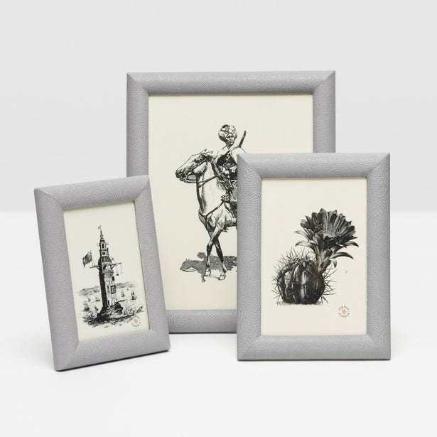 Three Pigeon and Poodle Oxford Faux Shagreen Frames in Ash Gray elegantly display art of a lighthouse, a horseback rider, and a cactus.