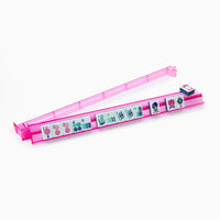 The Oh My Mahjong Mahjong Rack & Pusher Set - Multi features a pink acrylic rack holding Mahjong tiles with symbols and numbers, plus stacked betting chips. Ideal for use with pushers, it stands out beautifully against a white background.