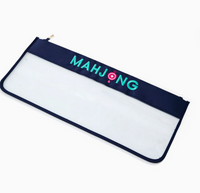 The Oh My Mahjong Tile Bags feature a navy blue and clear zippered design with "MAHJONG" printed in teal and pink letters on the blue section.