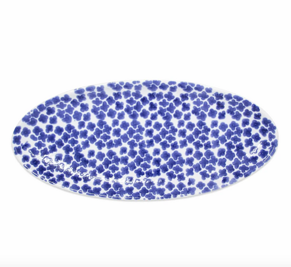 The Vietri Santorini Flower Narrow Oval Platter features a dense blue flower pattern on white, perfect for bringing Greek-inspired style to your table.