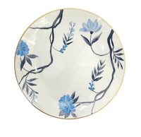 The Marie Daâge Bouquet De Vie 1 Dinnerware plate features blue flowers and dark gray leaves on white Limoges porcelain with a gold rim—ideal for luxury dinnerware collections.