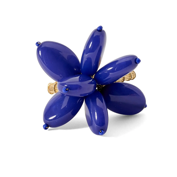 A set of four Deborah Rhodes Mod Stone Flower Napkin Rings, each featuring six deep blue oval beads in a floral design with gold accents—ideal for those who love modern, artistic table decor.