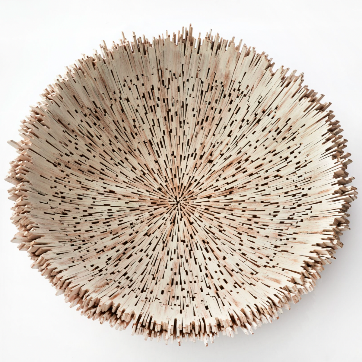 The Boracay Centerpiece Ivory Bowl by Lily Juliet features jagged, spiky edges and intricate cutouts that radiate from the center. This round wooden bowl is a sculptural artisan centerpiece, shown here on a white background.
