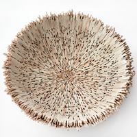 The Boracay Centerpiece Ivory Bowl by Lily Juliet features jagged, spiky edges and intricate cutouts that radiate from the center. This round wooden bowl is a sculptural artisan centerpiece, shown here on a white background.