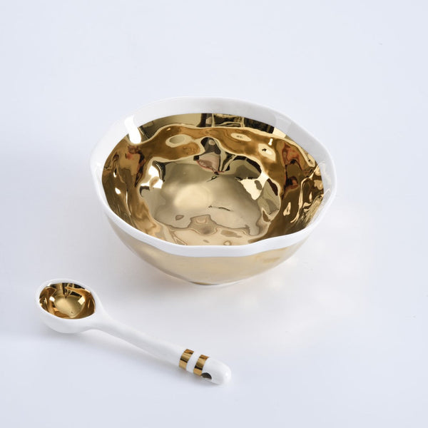 The PAMPA BAY Wavy Set Bowl and Spoon features a shiny gold interior and matching spoon with gold accents, creating an elegant appetizer or dipping bowl set displayed on a plain white surface.