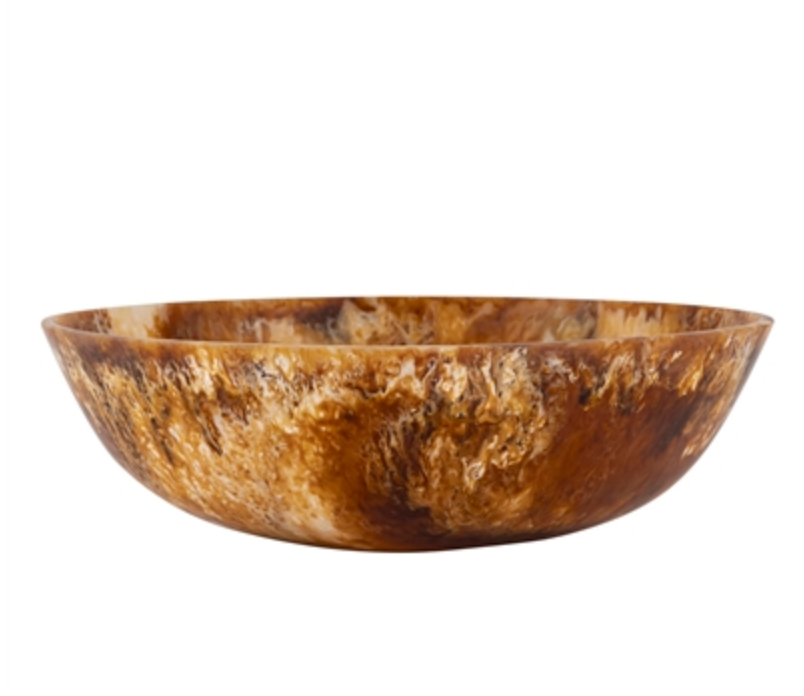 The BIDK Home Matteo Resin Bowl - Tortoise 19.5" features a round, shallow shape with a marbled brown and amber finish, evoking natural horn or stone for a striking centerpiece against any plain white background.