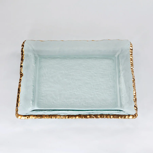The Annieglass Edgey Square Platter Gold 12" is a handmade, clear glass platter with a slightly textured surface and an uneven 24kt gold rim, shown on a plain white background.