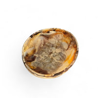 The Nashi Home Arila Small Bowl - Mocha showcases a marbled blend of amber, brown, and mocha with swirling wave-like patterns on a white background.