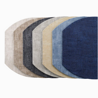 The Bodrum New Luster Elliptic Placemat Set of 4 features sturdy construction and elegant shades of beige, gray, blue, and navy on a white background, with each mat having one rounded corner for a modern look.