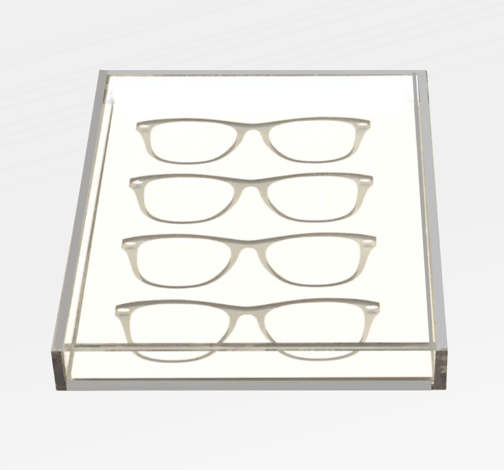 The Eye Candy Specs Eyeglass Tray is a clear rectangular acrylic holder displaying four pairs of eyeglasses frames in parallel rows on a white background, offering an elegant, luxury-inspired organization solution.