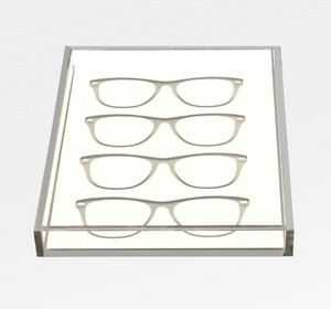 The Eye Candy Specs Eyeglass Tray is a clear rectangular acrylic holder displaying four pairs of eyeglasses frames in parallel rows on a white background, offering an elegant, luxury-inspired organization solution.
