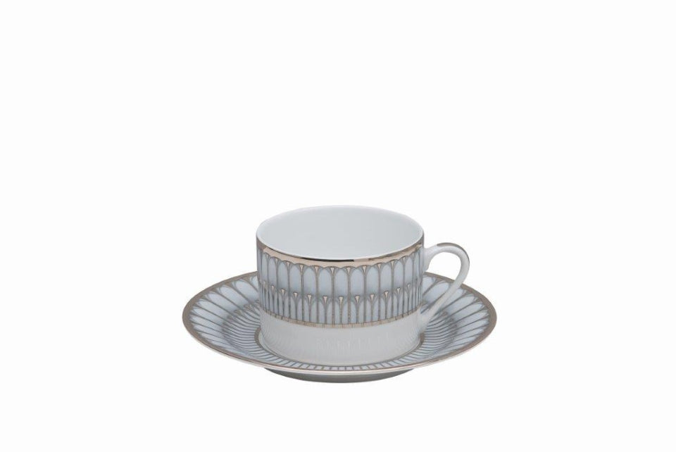 A white Arcades Platinum teacup with handle and matching saucer feature silver and gold geometric edges. Made in France by Philippe Deshoulieres BIA, set against a plain white background.