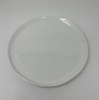 The Relish Simple White Melamine Dinnerware plate, a best seller, features a smooth surface with slightly uneven edges. Centered on a white background, this round plate is dishwasher safe.