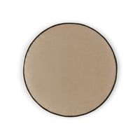 The Posh Circle Pillow 18″D - by D.V. KAP / Canaan Company is a round, beige pillow with a dark border, shown from above on a white background.