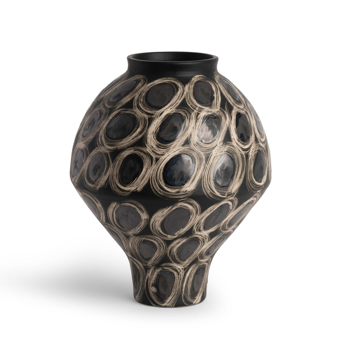 Introducing the Tessa Vase by FlowDecor Inc.—a striking black ceramic vase featuring a wide body and narrow neck, adorned with textured cream circular patterns in overlapping ring shapes for a bold, modern look. Set against a white background, this elegant piece makes the perfect statement addition to any contemporary space.