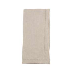 The Saro Trading Overlock Stonewash Border Napkin in beige, with visible stitched edges, adds a refined touch to your summer table collection—displayed neatly folded against a white background.