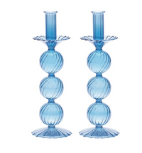 The Iris Candlestick Holder Set of 2 by Kim Seybert features blue hand-blown glass with three stacked, ribbed spheres forming the stem, and fluted bases and tops, standing side by side.