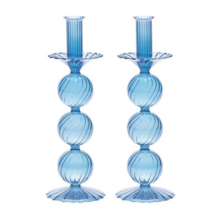 The Iris Candlestick Holder Set of 2 by Kim Seybert features blue hand-blown glass with three stacked, ribbed spheres forming the stem, and fluted bases and tops, standing side by side.