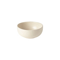 A small, round, off-white Costa Nova Pacifica Vanilla Dinnerware ceramic bowl with a smooth, speckled finish rests on a plain white background.