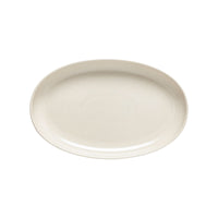 A smooth, oval, off-white ceramic plate from Costa Nova’s Pacifica Vanilla Dinnerware is set against a white background.