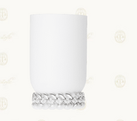 The Babylone Vase by Christofle is a handmade white porcelain cylinder with braided texture at the base, crafted in France and shown against a light background with subtle decorative watermark logos.