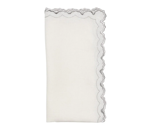 The Arches Napkin Set of 4 by Kim Seybert features folded white linen napkins with one scalloped, embroidered edge in wavy gray stitching, shown against a plain white background.