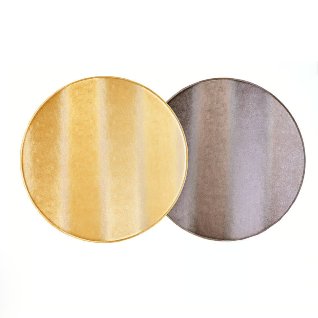 Two round rugs, in golden yellow and silvery gray, have a shiny, velvety surface reminiscent of the Textured Metallic Reversible Placemat Set of 4 by Von Gern Home, blending metallic sheen with easy-care style.