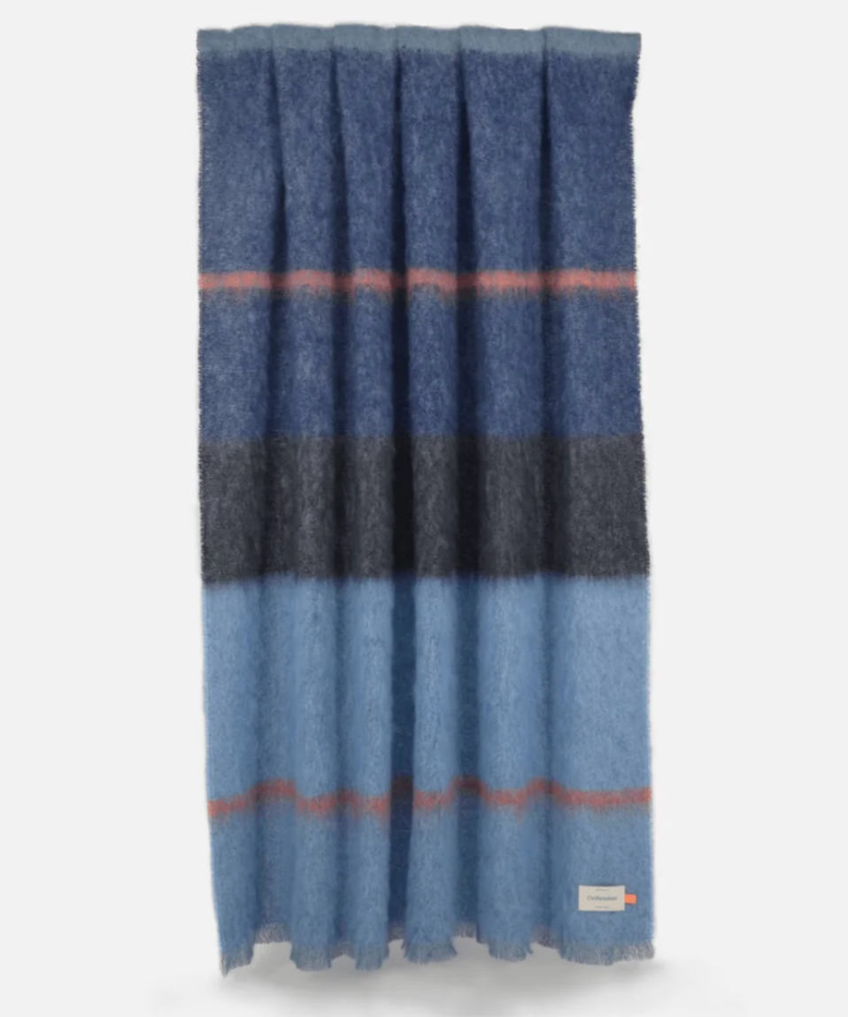 The Boher Extra Large Throw features wide horizontal stripes in shades of blue, grey, and rust with contemporary styling.