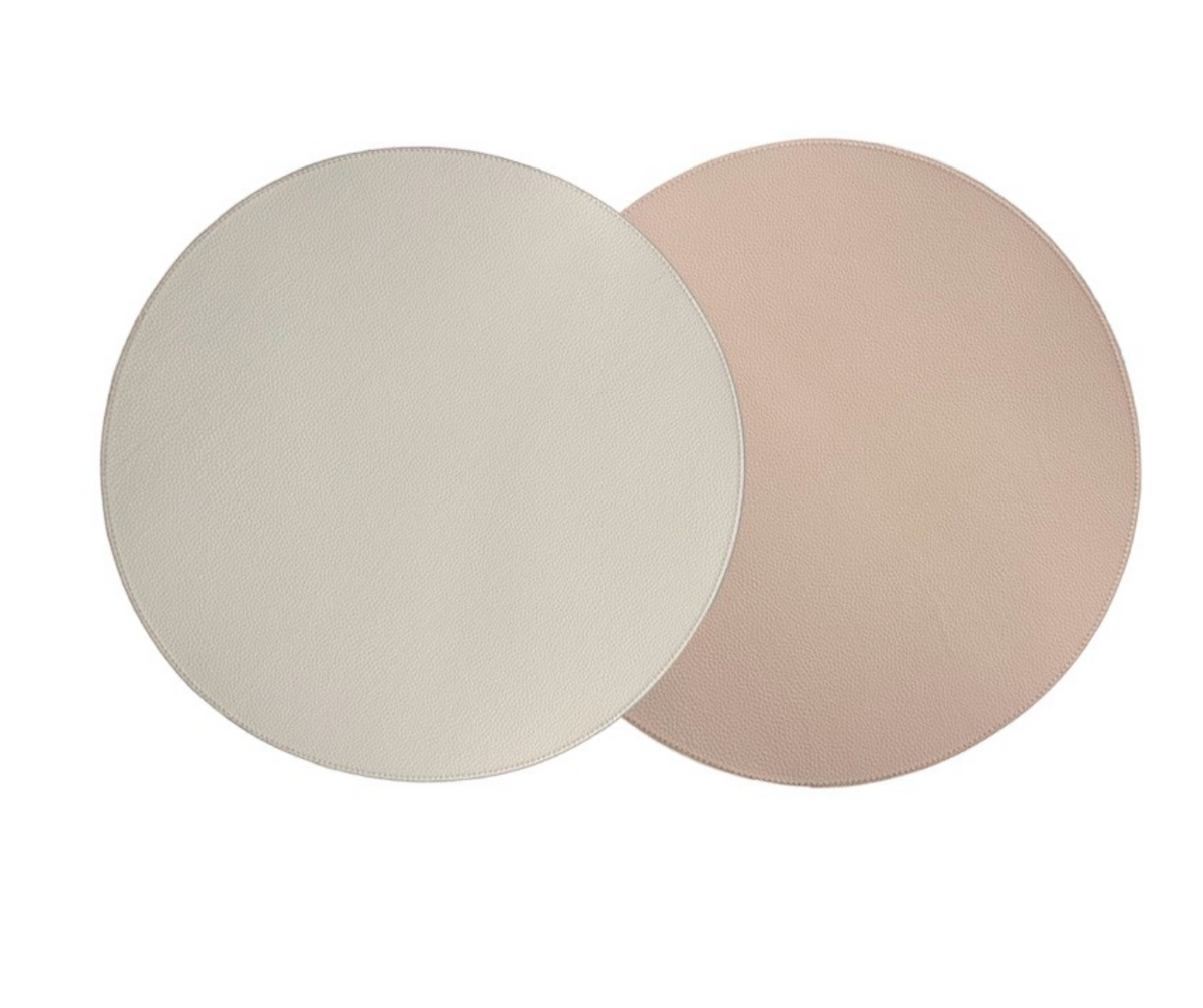 Two overlapping Von Gern Home Reversible Placemat s/4 on a white background; one light beige and the other soft blush pink, ideal for an elegant table setting.