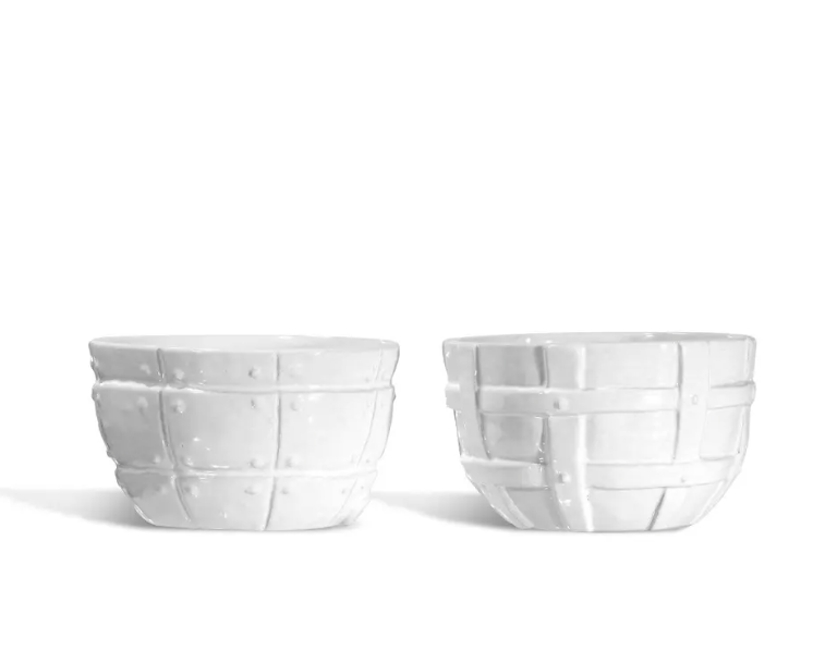 Two white ceramic bowls from Montes Doggett’s Serveware Set of 2 – Bowl 987, featuring raised grid and geometric patterns, are displayed side by side on a white background. These high-fired pieces are thoughtfully designed for everyday use, seamlessly blending durability with elegant craftsmanship.