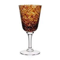The Vanessa Drinkware Tortoise by William Yeoward features a clear crystal stem and base with a marbled amber and brown bowl—ideal for lovers of luxury and tortoise-patterned drinkware.