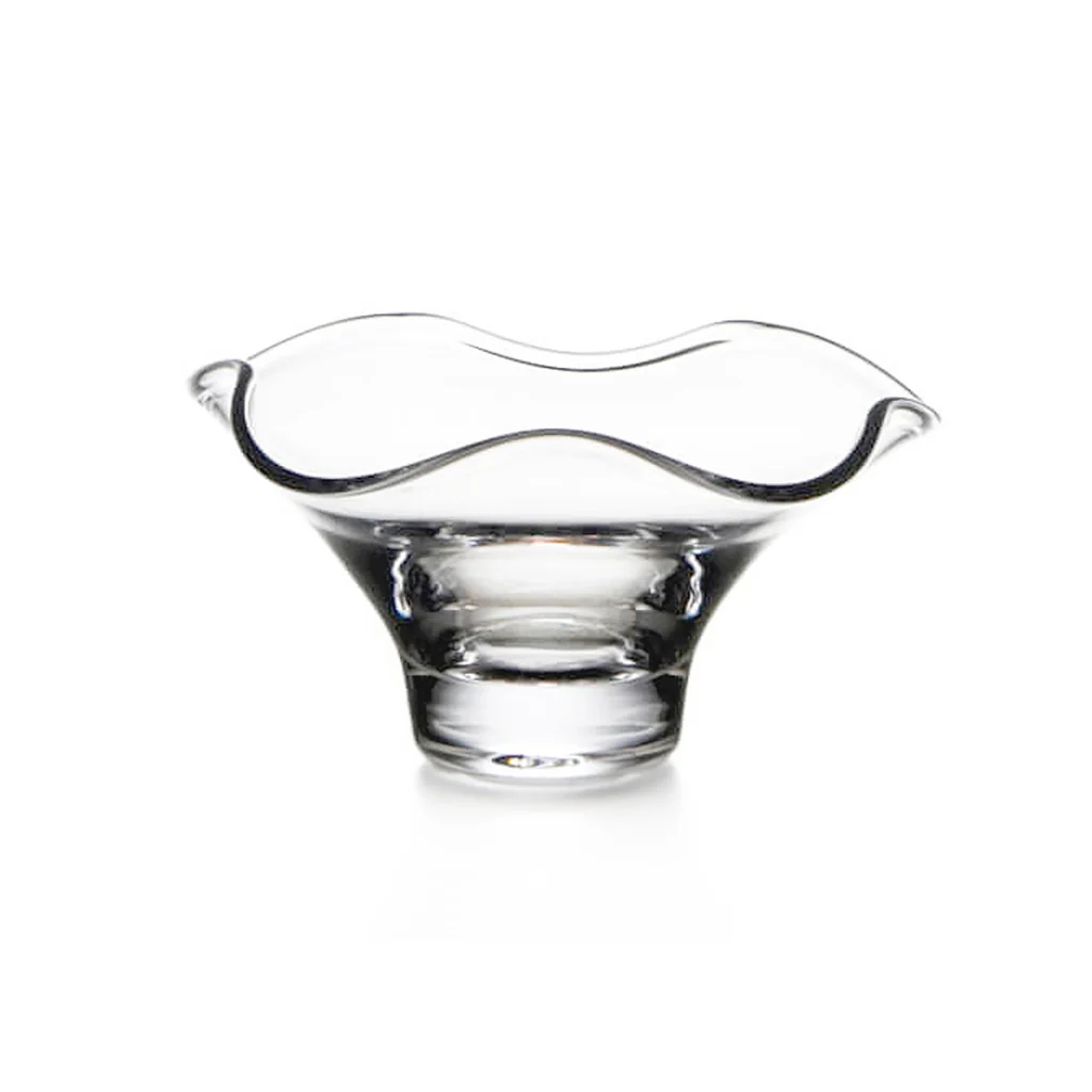 The Simon Pearce Chelsea Bowl features a wide, wavy, flared rim and stands on a round base. This handmade glass bowl is elegantly presented against a white background.