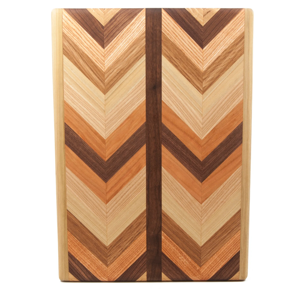 Multiwood Herringbone Serving Board by Dickinson Woodworking—features a rectangular design with a chevron (herringbone) pattern in various shades of brown and beige, accented by two dark brown central stripes.