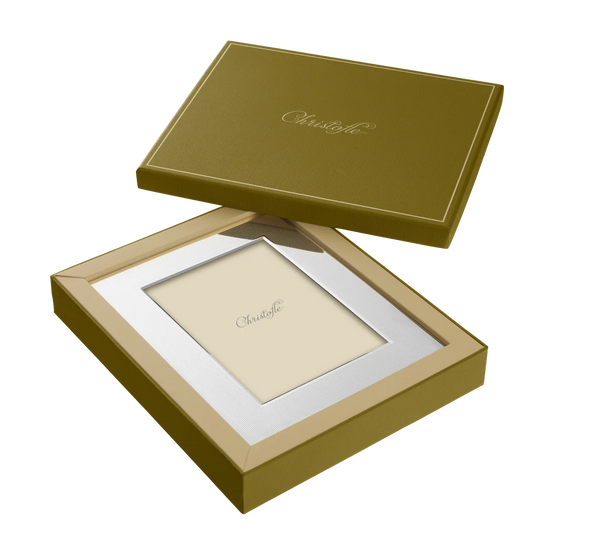 A Christofle America Stainless Steel Frame is shown in an open matching box, with the Christofle name visible on both the frame insert and box lid. The background is white.