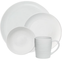 The Bernardaud Origine Dinnerware White set includes a large dinner plate, salad plate, bowl, and mug in Limoges porcelain with a subtle textured pattern.