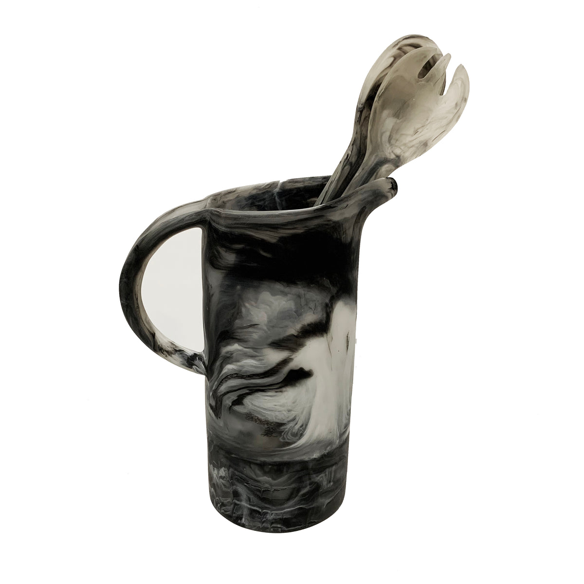 The Nashi Home Swirl Resin Classic Pitcher in black and white, paired with matching marbled serving fork and spoon, is shatterproof and dishwasher safe. Set against a plain white background, it’s perfect for easy cleanup.