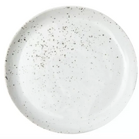 This handcrafted round white ceramic plate features an uneven pattern of black speckles and is part of the Marcus Dinnerware - White Salt Glaze - Set of 4- by Blue Pheasant.