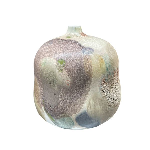 The KleinReid Rio Ipanema New Neutral Vase is a rounded, hand-painted ceramic piece with a small opening and a textured, multicolored glaze in soft brown, green, blue, and cream hues inspired by abstract organic patterns.