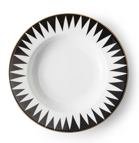 The Punk Dinnerware by Molecot is a round white Limoges porcelain plate with a black geometric sunburst rim and thin gold edge—a striking piece of modern tableware.