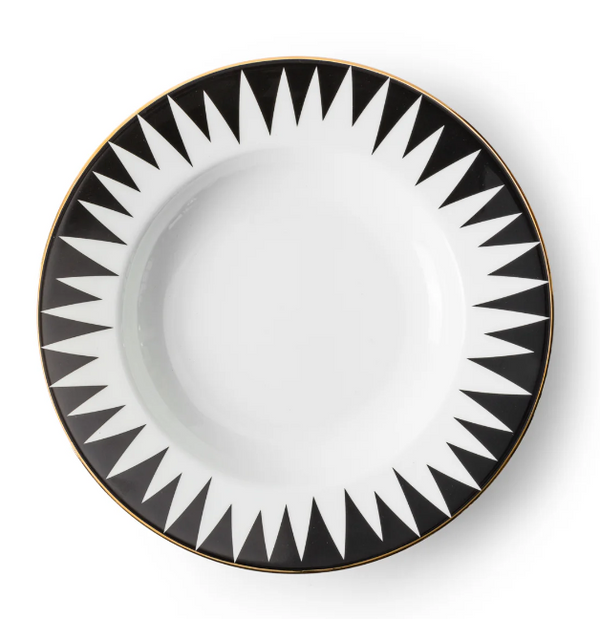 The Punk Dinnerware by Molecot is a round white Limoges porcelain plate with a black geometric sunburst rim and thin gold edge—a striking piece of modern tableware.