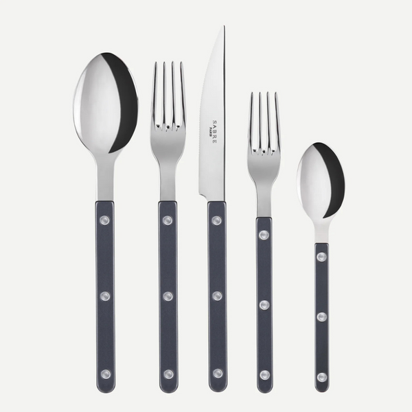 The Sabre Bistrot Pearly 5 Piece Setting - Shiny features black-handled cutlery with metal rivets: tablespoon, dinner fork, dinner knife, salad fork, and teaspoon shown upright on a white background. Made in France.