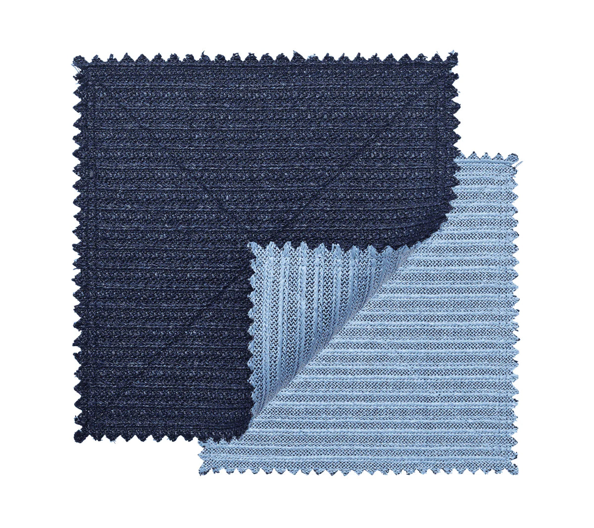 The Kim Seybert Vista Reversible Placemat s/4 in Navy & Periwinkle features two square, ribbed-textured placemats with zigzag edges; the navy piece overlaps the periwinkle one, whose corner is folded to show both reversible sides.