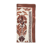 The Kim Seybert Botanica Napkin Ivory & Brown Set of 4 features ivory napkins with brown and rust floral designs and a brown border—ideal for enhancing autumn table settings.