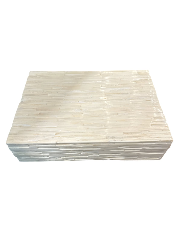 Certainly! Here’s the rewritten sentence using your product data: The Bone Tiles Box Ivory - Medium by A Sanoma Inc is a rectangular, ivory-colored box crafted from textured bone tiles in a mosaic pattern of stacked horizontal lines, shown against a white background.