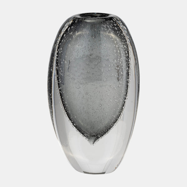 The Sagebrook Home Orbit Vase Smoke features a clear, oval-shaped glass design with embedded air bubbles and a smooth, glossy finish, displayed on a plain white background.