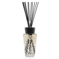 The Baobab Pearls Diffuser is a luxury fragrance piece with a black cap, slim black reeds, and light-colored liquid. Its textured glass features gold and white accents, providing elegant decor and scent for any space.