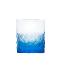 The Moser Pebbles DOF 370 ml is a hand-blown, lead-free Czech crystal whisky tumbler featuring round, raised textures on the lower half and a color fade from deep blue at the base to clear at the top.